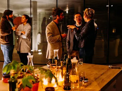 business professionals talking casually in groups at an evening event